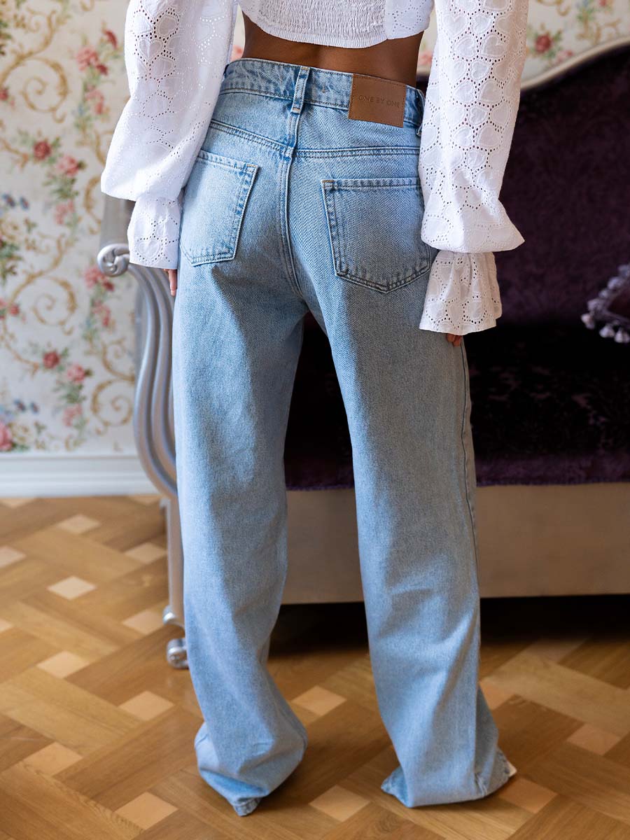 Blue jeans with cutouts at the waist